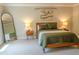 Bright bedroom with decorative wall art, a side table with lamps, and a full length mirror at 660 Stately Dr, Woodstock, GA 30188