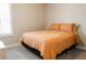 Cozy bedroom featuring carpeted floors, a window, and a comfortable bed with orange bedding at 660 Stately Dr, Woodstock, GA 30188