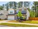 Charming two-story home with a stone facade, well-maintained lawn, and attached two-car garage at 660 Stately Dr, Woodstock, GA 30188