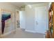 Hallway with carpet and two doors; stairway visible in the background at 660 Stately Dr, Woodstock, GA 30188