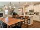 Modern kitchen with a quartz countertop island, stainless steel appliances, and an adjacent dining area at 660 Stately Dr, Woodstock, GA 30188