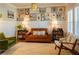 Cozy living room with a leather couch, eclectic wall art, and comfortable armchairs at 660 Stately Dr, Woodstock, GA 30188
