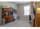 Bright upstairs playroom featuring two windows, carpet, and plenty of storage at 660 Stately Dr, Woodstock, GA 30188