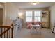 Bright upstairs playroom featuring two windows, carpet, and plenty of storage at 660 Stately Dr, Woodstock, GA 30188