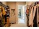 Large walk-in closet with built-in shelving and drawers, providing ample storage space and access to the bedroom at 660 Stately Dr, Woodstock, GA 30188