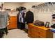 Spacious walk-in closet with wooden drawers and ample storage space for clothes and personal items at 660 Stately Dr, Woodstock, GA 30188