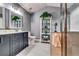 Modern bathroom with dual vanity, glass-enclosed shower, and a soaking tub at 7750 Carnegie Dr, Fairburn, GA 30213