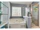Modern bathroom with an enclosed glass shower, and a corner whirlpool tub at 7750 Carnegie Dr, Fairburn, GA 30213