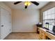 Bright bedroom with natural light, neutral carpet, ceiling fan, and closet at 7750 Carnegie Dr, Fairburn, GA 30213