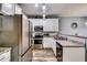 Well-equipped kitchen featuring stainless steel appliances, granite counters, and white cabinetry at 7750 Carnegie Dr, Fairburn, GA 30213