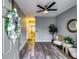 Inviting living area with stylish gray walls, hardwood flooring, and modern ceiling fan at 7750 Carnegie Dr, Fairburn, GA 30213