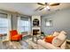 Comfortable living room featuring a corner fireplace, plush seating, and large windows with natural light at 7750 Carnegie Dr, Fairburn, GA 30213