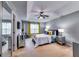 Spacious primary bedroom featuring tray ceilings, plush carpet, and lots of natural light at 7750 Carnegie Dr, Fairburn, GA 30213