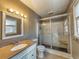 Bathroom featuring a glass shower and vanity with abundant lighting creates a relaxing atmosphere at 11511 Highway 92, Woodstock, GA 30188