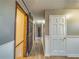 This hallway features wood-look floors, wainscoting and neutral paint at 11511 Highway 92, Woodstock, GA 30188