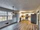 Bright kitchen boasts stainless steel appliances, white cabinetry, and hardwood flooring at 11511 Highway 92, Woodstock, GA 30188