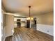 Charming kitchen features stainless steel appliances, white cabinets, and modern hardwood flooring at 11511 Highway 92, Woodstock, GA 30188