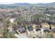 Aerial view of the beautiful neighborhood with a lake, showcasing community with a two-story brick home with double balcony at 2930 Aquitania Ln, Cumming, GA 30040