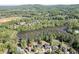 Aerial view of the property and surrounding neighborhood with mature trees and lake at 2930 Aquitania Ln, Cumming, GA 30040