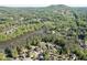 Aerial view showcasing homes in a lush green lakeside community surrounded by mature trees and rolling hills in the distance at 2930 Aquitania Ln, Cumming, GA 30040