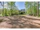 Expansive backyard featuring mature trees, lush greenery, and plenty of space for recreation and outdoor activities at 2930 Aquitania Ln, Cumming, GA 30040