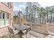 Inviting backyard deck with outdoor dining set, perfect for entertaining and enjoying the peaceful wooded views at 2930 Aquitania Ln, Cumming, GA 30040
