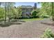 View of backyard with large brick home and stairs to upper porch at 2930 Aquitania Ln, Cumming, GA 30040