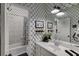 Charming bathroom featuring modern fixtures, stylish trellis wallpaper, and a shower-over-bath combo at 2930 Aquitania Ln, Cumming, GA 30040