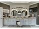 Elegant bathroom boasting double sinks, a TV, and stylish mirrors above a vanity area at 2930 Aquitania Ln, Cumming, GA 30040