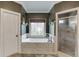 Relaxing bathroom showcasing a soaking tub, a separate shower, and neutral tile at 2930 Aquitania Ln, Cumming, GA 30040