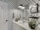 Stylish bathroom with patterned wallpaper, a modern vanity, and elegant fixtures at 2930 Aquitania Ln, Cumming, GA 30040