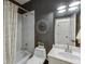 Full bathroom featuring a tub-shower, decorative accents and updated fixtures at 2930 Aquitania Ln, Cumming, GA 30040