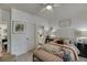 Comfortable bedroom with ensuite bathroom, ceiling fan and decorative accents at 2930 Aquitania Ln, Cumming, GA 30040