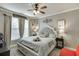 Serene bedroom with carpeted floors, a ceiling fan, and a large window with curtains at 2930 Aquitania Ln, Cumming, GA 30040