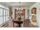 Elegant dining room featuring a chandelier, wainscoting, and a patterned rug at 2930 Aquitania Ln, Cumming, GA 30040