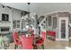 Open dining area with brick wall, fireplace, and view into living room at 2930 Aquitania Ln, Cumming, GA 30040