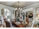 Dining room with hardwood floors, decorative chandelier and entryways visible at 2930 Aquitania Ln, Cumming, GA 30040