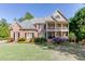 Charming two-story brick home with a double balcony and a beautifully landscaped front yard and a traditional design at 2930 Aquitania Ln, Cumming, GA 30040