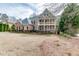 Well-maintained two-story brick home with a double balcony, a well-manicured lawn and tasteful landscaping details at 2930 Aquitania Ln, Cumming, GA 30040
