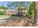 Charming two-story brick home with a double balcony and a landscaped front yard with traditional architectural details at 2930 Aquitania Ln, Cumming, GA 30040