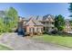 A beautiful two-story brick home featuring a double balcony, paved driveway and well-maintained landscaping at 2930 Aquitania Ln, Cumming, GA 30040