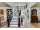 Spacious foyer features hardwood floors, staircase with iron railings, and views into the living areas at 2930 Aquitania Ln, Cumming, GA 30040