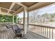 Inviting front porch with rocking chair and swing, overlooking a beautifully landscaped yard and a tree lined street at 2930 Aquitania Ln, Cumming, GA 30040