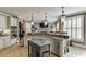 Modern kitchen with granite countertops, stainless steel appliances, and bar seating at 2930 Aquitania Ln, Cumming, GA 30040