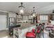 Well-lit kitchen with granite countertops, stainless appliances and bar stool seating at 2930 Aquitania Ln, Cumming, GA 30040