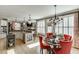 Open-concept kitchen with granite countertops, an island, and a cozy dining area at 2930 Aquitania Ln, Cumming, GA 30040