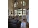 Open living room featuring floor-to-ceiling windows, hardwood floors, and a cozy fireplace at 2930 Aquitania Ln, Cumming, GA 30040