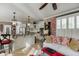 Cozy living room featuring elegant furnishings, a brick accent wall, and access to a modern kitchen with stainless steel appliances at 2930 Aquitania Ln, Cumming, GA 30040