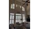 Bright living room boasts high ceilings, large windows with shutters, and comfortable seating at 2930 Aquitania Ln, Cumming, GA 30040