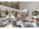 Spacious living room with a balcony view, featuring elegant decor, comfortable seating, and natural light at 2930 Aquitania Ln, Cumming, GA 30040